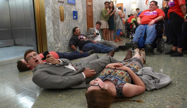 Healthcare and the economy were seen as top priorities for Congress by 24 percent, according to a new poll. Protesters lay on the floor in the hallways outside a congressional hearing on the last-ditch GOP push to overhaul the nation's healthcare system. (AP Photo/Susan Walsh)