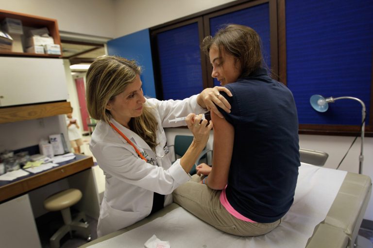 University of Miami pediatrician Judith L. Schaechter, M.D. (L) gives an HPV vaccination to a 13-year-old girl in her office at the Miller School of Medicine on September 21, 2011 in Miami, Florida. (Photo by Joe Raedle/Getty Images)
