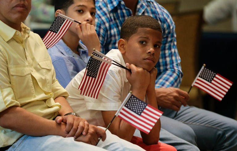 Derek Martinez listens during a ceremony to receive a citizenship certificate at the Bronx Zoo, Tuesday, May 26, 2015, in New York. (AP Photo/Julie Jacobson)
