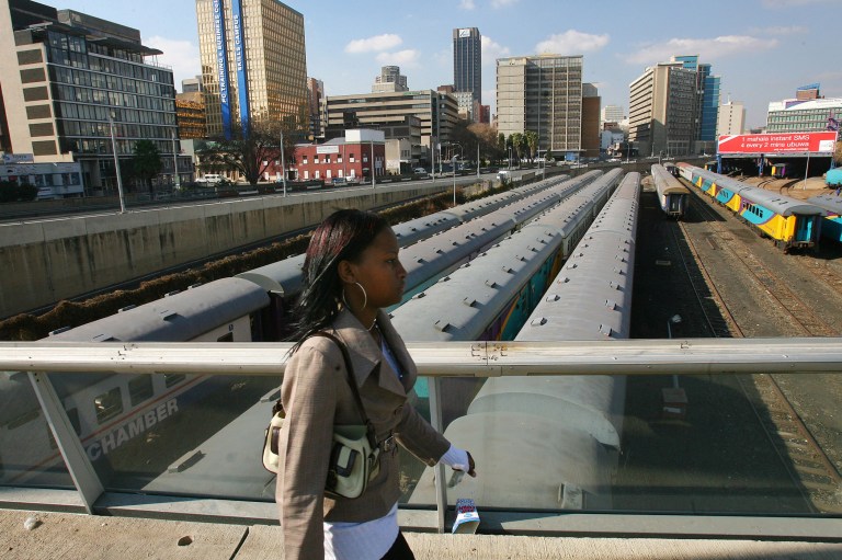   File: In this photo taken Thursday June 29, 2006 a Johannesburg resident walks on Mandela Bridge above trains over the railroad tracks in Johannesburg. South Africa has accepted a Canadian dlrs 5.8 billion (euro 4.5 billion) deal with French company Alstom SA to refurbish the nation's passenger trains. The deal is one of the largest ever signed by the government since the end of apartheid, the Passenger Rail Agency of South Africa announced the deal Wednesday Dec. 5, 2012. (AP Photo/Jerome Delay-file)  