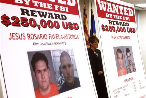 Laura E. Duffy, United States Attorney Southern District of California, is flanked by wanted posters as she speaks at a news briefing where Duffy announces the indictment of five suspects related to the death of U.S. Border Patrol agent Brian Terry, Monday, July 9, 2012, in Tucson, Ariz.  A reward of up to $1 million dollars for information leading to the arrest of  four fugitives was also announced by Department of Justice officials, on suspect is in custody.(AP Photo/Ross D. Franklin)