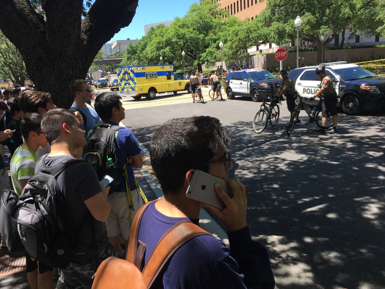 Students wait near the scene after a fatal stabbing attack on the University of Texas campus Monday, May, 1, 2017. (Tamir Kalifa/Austin American-Statesman via AP)
