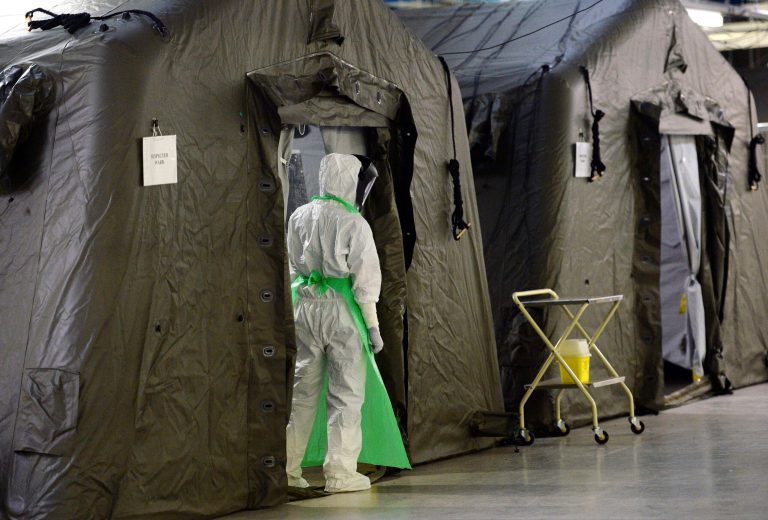 A British Army medic attached to 22 Field Hospital participates in an exercise at the Army Medical Services Training Centre near York, northern England, Tuesday, Oct. 7, 2014. More 100 British Army medics will travel to Sierra Leone to help tackle the Ebola crisis, where they will staff a field hospital set up specifically to treat medical personnel who have caught the disease. (AP Photo/PA, Anna Gowthorpe) UNITED KINGDOM OUT, NO SALES, NO ARCHIVE