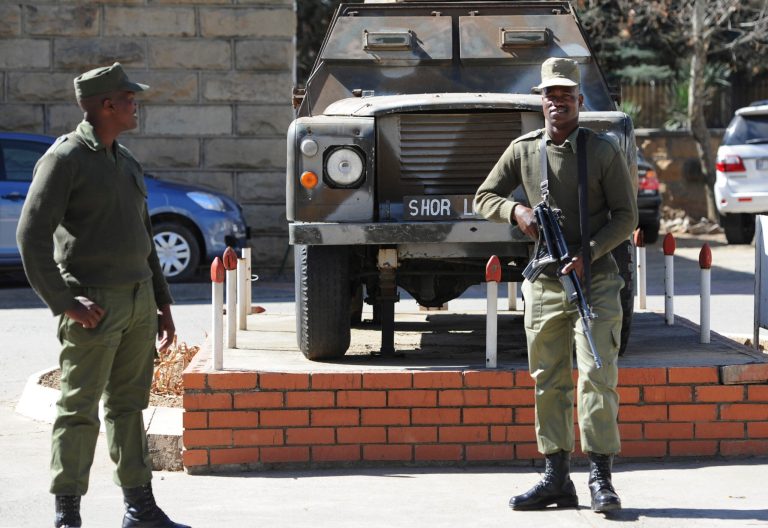 In this  Sunday,  Aug. 31, 2014 photo, army personnel man outside the military headquarters in Maseru, Lesotho.  Lesotho's prime minister fled to South Africa in fear for his safety and will now meet with leaders of the region there to seek peace, he said Sunday. Prime Minister Thomas Thabane said there had been an attempt to take over Lesotho, a country of about 2 million people that is surrounded by South Africa. Lesotho's Defense Forces deny any attempt at a coup although they say the military exchanged gunfire and disarmed two police stations in Lesotho's capital, Maseru, on Saturday. (AP Photo)