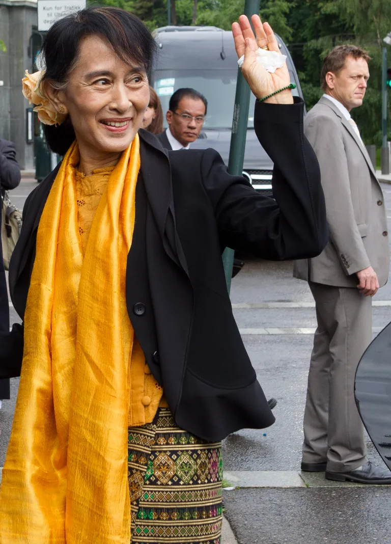   Myanmar opposition leader Aung San Suu Kyi waves as she arrives at the Foreign Ministry for a meeting with Norway's Foreign Minister Jonas Gahr Store in Oslo, Sunday, June 17, 2012. Myanmar opposition leader Aung San Suu Kyi said Saturday at a Nobel Prize lecture that the Nobel Peace Prize she won while under house arrest 21 years ago helped to shatter her sense of isolation and ensured that the world would demand democracy in her military-controlled homeland. (AP Photo/Markus Schreiber)  