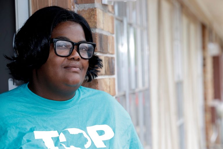 Swan Lockett stands for a photo in the doorway of her Houston apartment, Monday, April 21, 2014. Lockett said she was unable to get an affordable health care plan on the federal marketplace. The federal health care overhaul is providing coverage for millions of Americans, but it has only chipped away at one of its core goals to sharply reduce the number of people without insurance. (AP Photo/David J. Phillip)