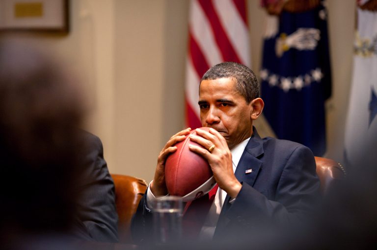 President Obama listens to comments holding a football during a briefing with advisers in preparation for an upcoming meeting with Democratic members of the House Energy and Commerce Committee in the Roosevelt Room of the White House on May 4, 2009 in Washington. (Photo by Pete Souza/White House via Getty images)