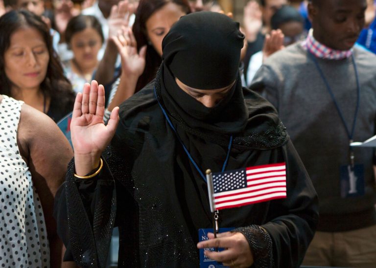 A participant from Bangladesh takes the Naturalization Oath of Allegiance to the United States of America Friday, June 30, 2017, during an naturalization ceremony at the New York Public Library in New York. Over 190 immigrants from 59 countries became American citizens at the fourth annual Independence Day naturalization ceremony hosted by the library. (AP Photo/Michael Noble Jr.)