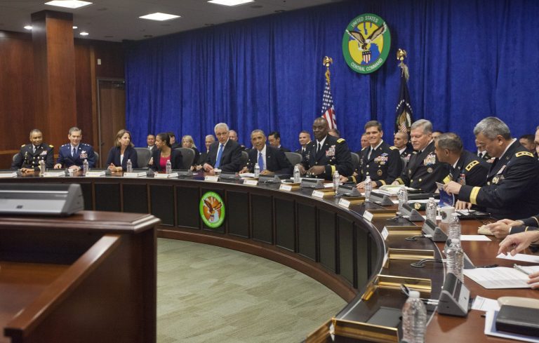 President Barack Obama, center, before the start of a briefing at US Central Commandat MacDill Air Force Base, Fla., Wednesday. Obama was updated on the ongoing military campaigns in Iraq and Syria. (AP Photo/Pablo Martinez Monsivais)