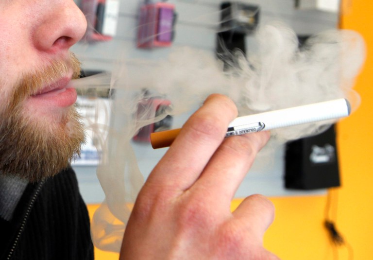 A sales associate demonstrates the use of a electronic cigarette and the smoke like vapor that comes from it in Aurora, Colo. on March 2, 2011.ÃÂ The electronic cigarette industry is booming, with sales doubling annually since 2008 and revenue expected to reach at least $1.5 billion this year.ÃÂ (AP Photo/Ed Andrieski)