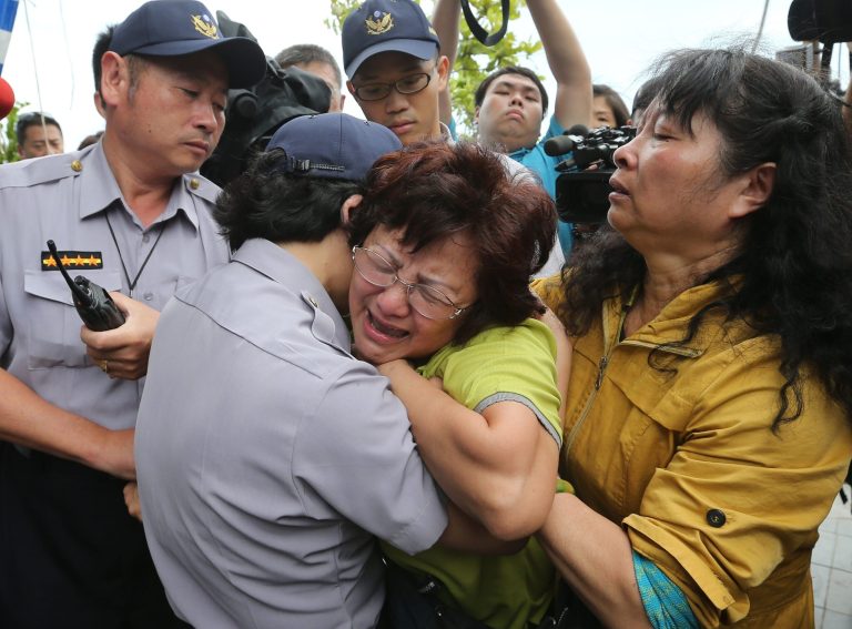 A relative of a passenger onboard the TransAsia Airways Flight GE222 that crashed on the Taiwanese island of Penghu, cries at a funeral parlor in Penghu, Taiwan, Thursday, July 24, 2014. The plane attempting to land in stormy weather crashed on the island late Wednesday, killing dozens of people and wrecking houses and cars on the ground. (AP Photo) TAIWAN OUT