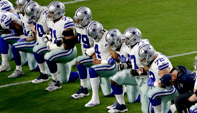 On Monday evening, the entire Dallas Cowboys team took the field before the national anthem and collectively knelt in a moment of silence to protest police brutality against blacks. But after, the team all stood up for the national anthem. (AP Photo/Matt York)