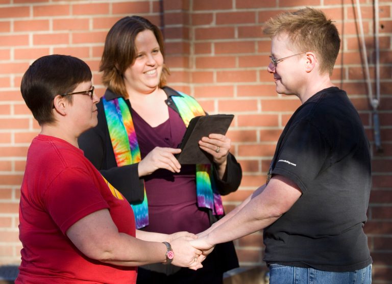 Tabitha Simmons, left, and Katherine Sprague, right, are married by Rev. Elizabeth Stevens, from the Unitarian Universalist Church of the Palouse, outside the Latah County Courthouse in Moscow, Idaho, on Friday, Oct. 10, 2014. Sprague and Simmons were the first couple to be issued a same-sex marriage license in Latah County. (AP Photo/Moscow-Pullman Daily News, Geoff Crimmins)