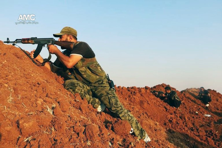 This Sunday, Aug. 17, 2014 photo provided by the anti-government activist group Aleppo Media Center (AMC), which has been authenticated based on its contents and other AP reporting, shows a Free Syrian Army fighter aiming his weapon during a battle with Islamic State militants in Aleppo, Syria. Members of the Islamic State group have been marching in the northern province of Aleppo capturing areas under the control of the mainstream Free Syrian Army. Islamic State fighters have overrun nearly a dozen towns and villages in Aleppo province last week crushing what little resistance they have encountered. (AP Photo/Aleppo Media Center AMC)