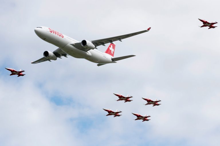 Escorted by six Tiger F5-E jets an Swiss airline Airbus A330 flies above  the spectators of an  air show in Payerne, Switzerland, Saturday, Aug.  30, 2014. Swiss air force celebrate it's 100.  bicentenary with a big air show.  (AP Photo/Keystone,Alessandro della Valle)