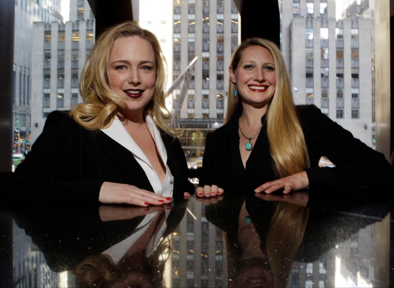 In this Thursday, April 24, 2014 photo, Crystl Faye Horton-Friedman, right, and Kristin Beckler, left, pose for a photo at Del Frisco's in New York. Both women are mothers and work as sommeliers at the restaurant. More women are moving up the wine ranks, said Dorothy Cann Hamilton, founder and CEO of the International Culinary Center. (AP Photo/Frank Franklin II)
