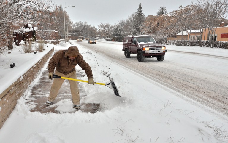   Arnoldo Campos shovels snow from the sidewalk in front of the Gerald Peters Gallery at 1011 Paseo de Peralta, Santa Fe, New Mexico Monday morning, December 31, 2012. Campos is employed by Peters. Clyde Mueller/The New Mexican (AP Photo/The Santa Fe New Mexican, )  
