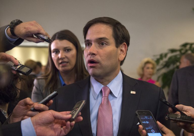 Republican presidential candidate Sen. Marco Rubio talks to the media on his way to attend a closed briefing for senators on Iran. (AP Photo/Molly Riley)