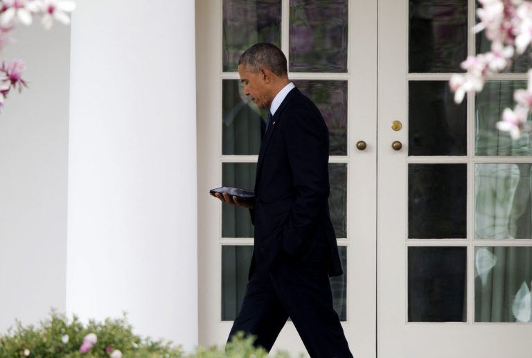 President Barack Obama reads as he walks back to the Oval Office of the White House in Washington, Tuesday, April 7, 2015. (AP Photo/Pablo Martinez Monsivais)