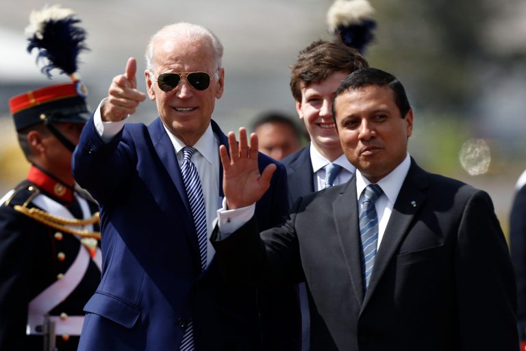 U.S. Vice President Joe Biden, left, and Guatemalan foreign minister, Carlos Raul Morales wave to the press as Biden arrives at the air force base in Guatemala City. (AP Photo/Moises Castillo)