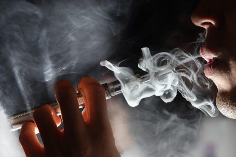 In this photo illustration, a man smokes an E-Cigarette at the V-Revolution E-Cigarette shop in Covent Garden on August 27, 2014 in London, England. (Photo by Dan Kitwood/Getty Images)