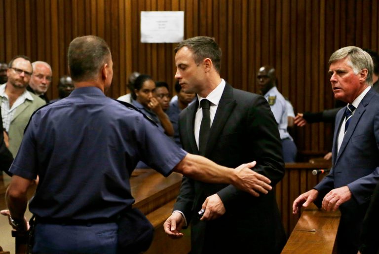 Oscar Pistorius, center, is led out of court in Pretoria, South Africa, Tuesday, Oct. 21, 2014.  Pistorius received a five-year prison sentence for culpable homicide by judge Thokozile Masipais for the killing of his girlfriend Reeva Steenkamp last year (AP Photo/Themba Hadebe)