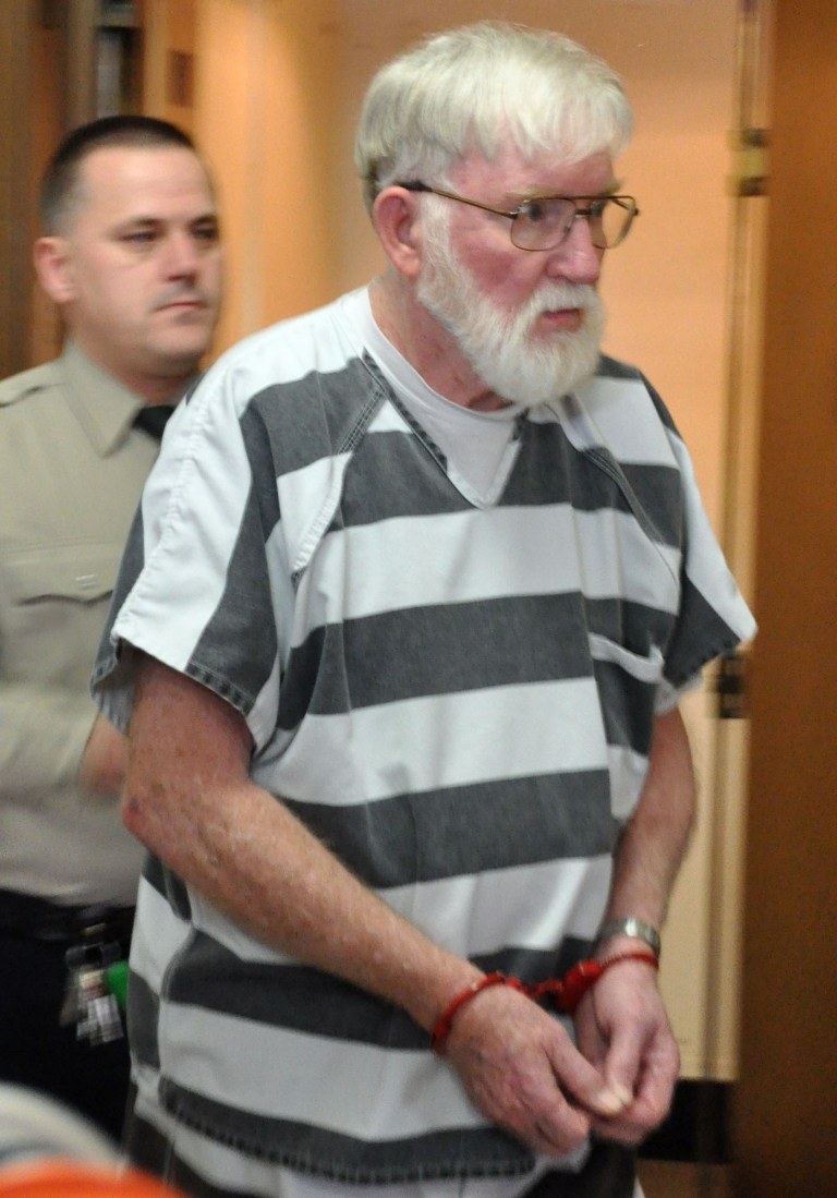   In this Feb. 2, 2012 file photo, Carl V. Ericsson, 73, is led into a Lake County courtroom for a bond hearing on a first-degree murder charge in Madison, S.D. Ericsson was sentenced to life in prison Friday, June 15, 2012, after pleading guilty but mentally ill last month to second-degree murder. Ericsson was charged in the Jan. 31 killing of retired Madison High School teacher and track coach Norman Johnson, who KSs shot twice in the face. (AP Photo/Dirk Lammers)  