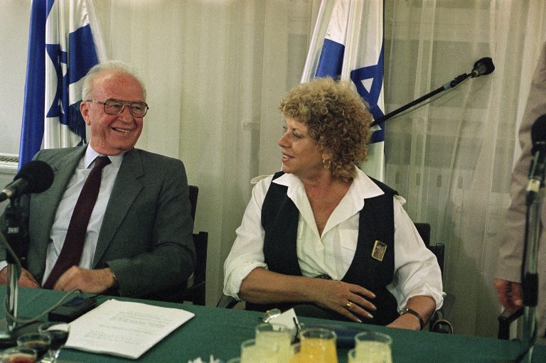 FILE - In this May 11, 1993 file photo, Israeli Prime Minister Yitzhak Rabin and Education Minister Shulamit Aloni share a laugh during the signing of a teacher's union contract at the Prime Minister's office in Jerusalem. Aloni, an Israeli civil rights pioneer and longtime dovish politician, has died at the age of 85.  (AP Photo/Nat Harnik, File)