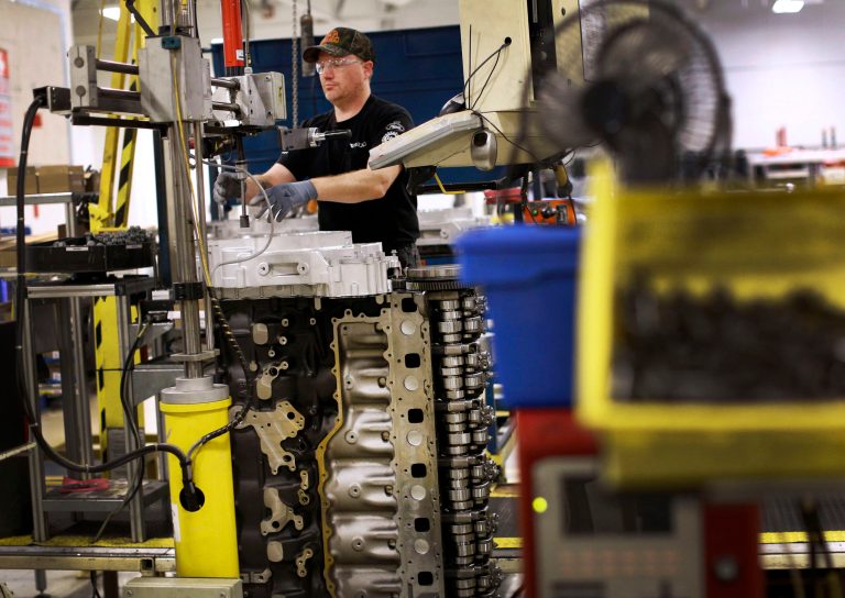 In this March 26, 2014 photo, Jerry Drury installs parts on a truck engine assembly line at Volvo Trucks' powertrain manufacturing facility in Hagerstown, Md.  The Federal Reserve releases industrial production figures for May on Monday, June 16, 2014. (AP Photo/Patrick Semansky)