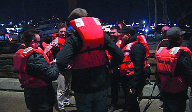This image provided by KTVU-TV shows some of the 22 rescued passengers on the pier Friday Oct.12, 2012 in San Francisco. A U.S. Coast Guard spokesman said the wine-tasting boat, Neptune hit a shoal near Alcatraz Island and began sinking. Nearly two dozen people who were enjoying a boat ride on what's billed as San Francisco Bay's only 