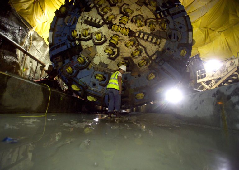   In this photo taken Friday, Oct. 7, 2011, Robin Rockey with Southern Nevada Water Authority stands in front of the tunnel boring machine in the Lake Mead Intake No. 3 tunnel on Friday, Oct. 7, 2011. The project is scheduled to be completed in 2014. Ninety percent of Las Vegas water comes from Lake Mead, which has shrunk in recent years due to ongoing drought and increasing demand from the seven states and more than 25 million people who share Colorado River water rights under agreements dating to 1922. (AP Photo/Las Vegas Review-Journal, Jeff Scheid)  