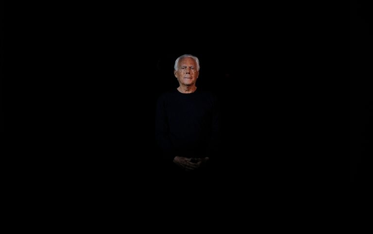 Italian fashion designer Giorgio Armani acknowledges the applause at the end of his Giorgio Armani women's Fall-Winter 2014-15 collection, part of the Milan Fashion Week, unveiled in Milan, Italy, Monday, Feb. 24, 2014. (AP Photo/Giuseppe Aresu)