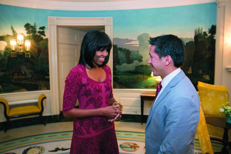 In this image released by the White House, first lady Michelle Obama greets David Hall, one of eight citizen co-chairs for the Inauguration, in the Diplomatic Reception Room of the White House in Washington, Thursday, Jan. 17, 2013. The photo is showing something different about Obama - bangs in her hair. (AP Photo/The White House, Lawrence Jackson)