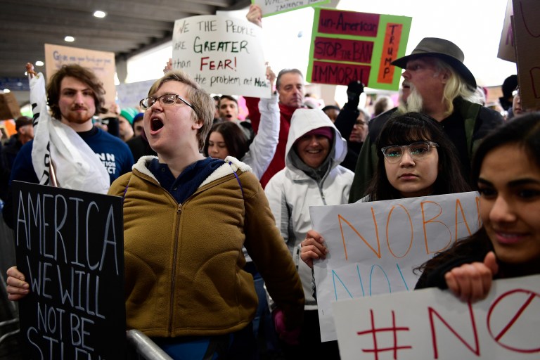 Natalie Swarts of Philadelphia calls out protest chants as the crowd follows in cadence during a protest of President Donald Trump's travel ban on refugees and citizens of seven Muslim-majority nations, Sunday, Jan. 29, 2017, at Philadelphia International Airport in Philadelphia. (AP Photo/Corey Perrine)