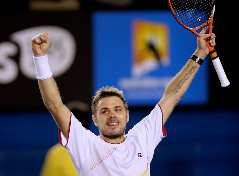 Stanislas Wawrinka of Switzerland celebrates after defeating Novak Djokovic of Serbia in their quarterfinal at the Australian Open tennis championship in Melbourne, Australia, Tuesday, Jan. 21, 2014.(AP Photo/Rick Rycroft)