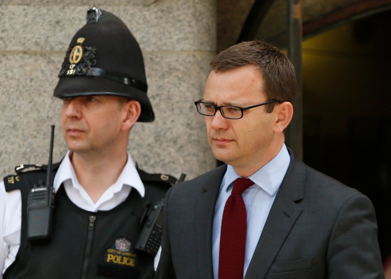 Andy Coulson, former News of the World editor and the former spin doctor of British Prime Minister David Cameron, leaves the Central Criminal Court in London, Wednesday, June 25, 2014. Coulson was convicted of phone hacking Tuesday, but fellow editor Rebekah Brooks was acquitted after a monthslong trial centering on illegal activity at the heart of Rupert Murdoch's newspaper empire. A judge on Wednesday dismissed the jury at Britain's phone-hacking trial after it failed to reach a verdict on two final counts, having convicted him of hacking a day earlier. Judge John Saunders ended the trial after jurors said they could not agree whether Coulson and ex-royal editor Clive Goodman were guilty of paying police officers for royal phone directories. Prosecutors said they would announce next week whether they would seek a retrial. (AP Photo/Lefteris Pitarakis)