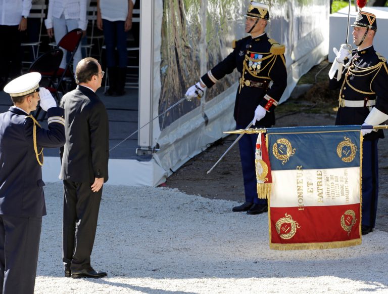 French President Francois Hollande pays respect to the French National flag during ceremony for the victims of July 14 attack in Nice, Saturday, Oct. 15, 2016. French citizens are pessimistic about 2017 too. (AP Photo/Claude Paris)