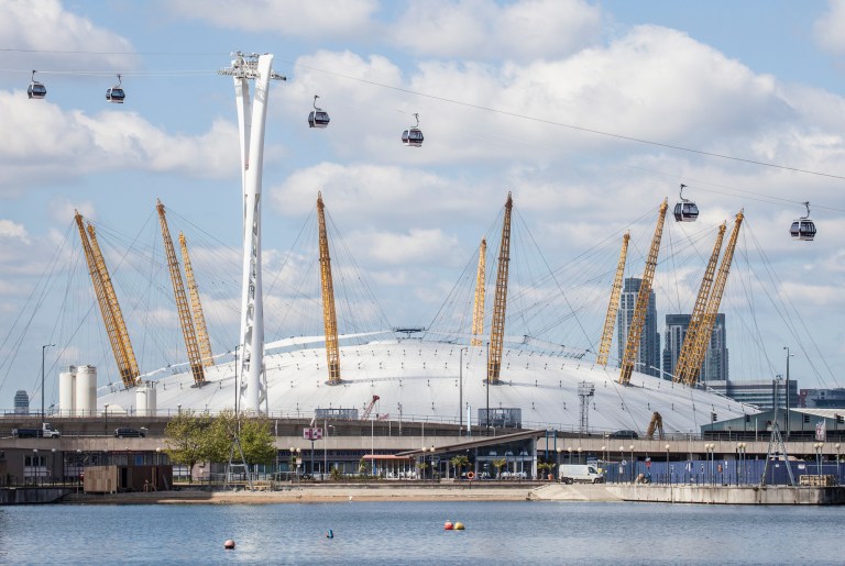   In this image made available Monday June 18, 2012 by the Transport for London the new a cable car crosses of the River Thames past the O2 arena in Greenwich London. Transport for London said Monday June 18, 2012 it will start operating Britain's first urban cable car at the end of June â in time for the crowds expected for the Olympics. The cable car will make the half mile (one kilometre) crossing between Greenwich and the Royal Docks starting June 28.(AP Photo/John Sturrock, Transport for London)  