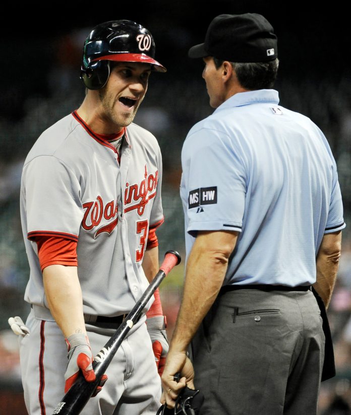 Washington Nationals' Bryce Harper, left, talks with home plate umpire Angel Hernandez after striking out in the fourth inning of a baseball game against the Houston Astros, Wednesday, Aug. 8, 2012, in Houston. (AP Photo/Pat Sullivan)