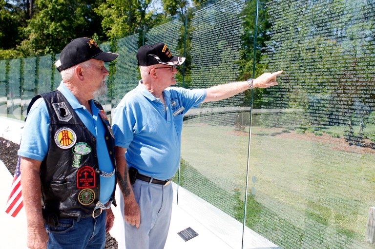 Donald Odum, left, junior vice president of the Onslow Vietnam Veterans Memorial Foundation, and Michael Rooney look over the memorial in Jacksonville, N.C., Friday afternoon, May 23, 2014. (AP Photo/The Jacksonville Daily News, Maria Sestito)