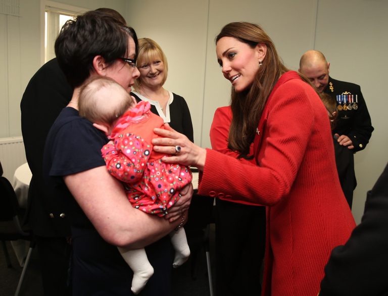 FILE - In this Friday, April 5, 2013, Kate, the Duchess of Cambridge, right, talks to members of the crew and their families as she visits the Astute-class Submarine Building at BAE Systems in Barrow-in-Furness, England. If you believe the bookmakers, the first child of Prince William and the Duchess of Cambridge will be a girl named Alexandra. The British betting firm Coral has slashed the odds on the royal baby's name to 2-1 from 25-1 after receiving an unusually large flurry of bets on it, a spokesman said Thursday, April 11, 2013. (AP Photo/Chris Jackson, Pool-File)