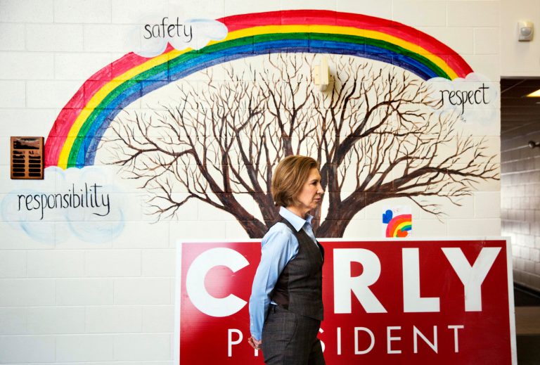 Former Republican presidential candidate Carly Fiorina stands in front of a mural in the hallway while waiting to be introduced at a campaign event at Maple Avenue Elementary School Saturday, Feb. 6, 2016, in Goffstown, N.H. (AP Photo/David Goldman)