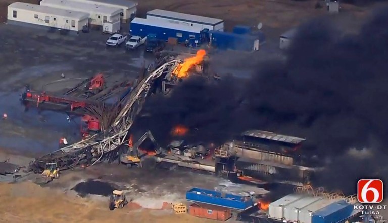 In this Jan. 22, 2018 file photo provided from a frame grab by Tulsa's KOTV/NewsOn6.com, fires burn at an eastern Oklahoma drilling rig near Quinton, Okla. Five people workers were killed after a fiery explosion ripped through a drilling rig, sending plumes of black smoke into the air and leaving a derrick crumpled on the ground, emergency officials said. Federal records show 10 workers have died over the past decade at well sites linked Patterson-UTI, the same driller involved in this week's rig explosion. (Christina Goodvoice, KOTV/NewsOn6.com via AP)