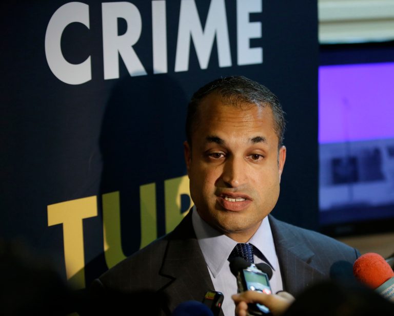 Interpol Digital Crime Centre Director Sanjay Virmani, is interviewed by reporters following a news conference Friday, May 2, 2014 at the Philippine National Police Headquarters at suburban Quezon city northeast of Manila, Philippines. Philippine police, backed by Interpol, have arrested dozens of suspected members of an online extortion syndicate who duped hundreds of victims worldwide into exposing themselves in front of webcams or engaging in lewd chats, including a Scottish teenager who committed suicide after being blackmailed, officials said.  (AP Photo/Bullit Marquez)