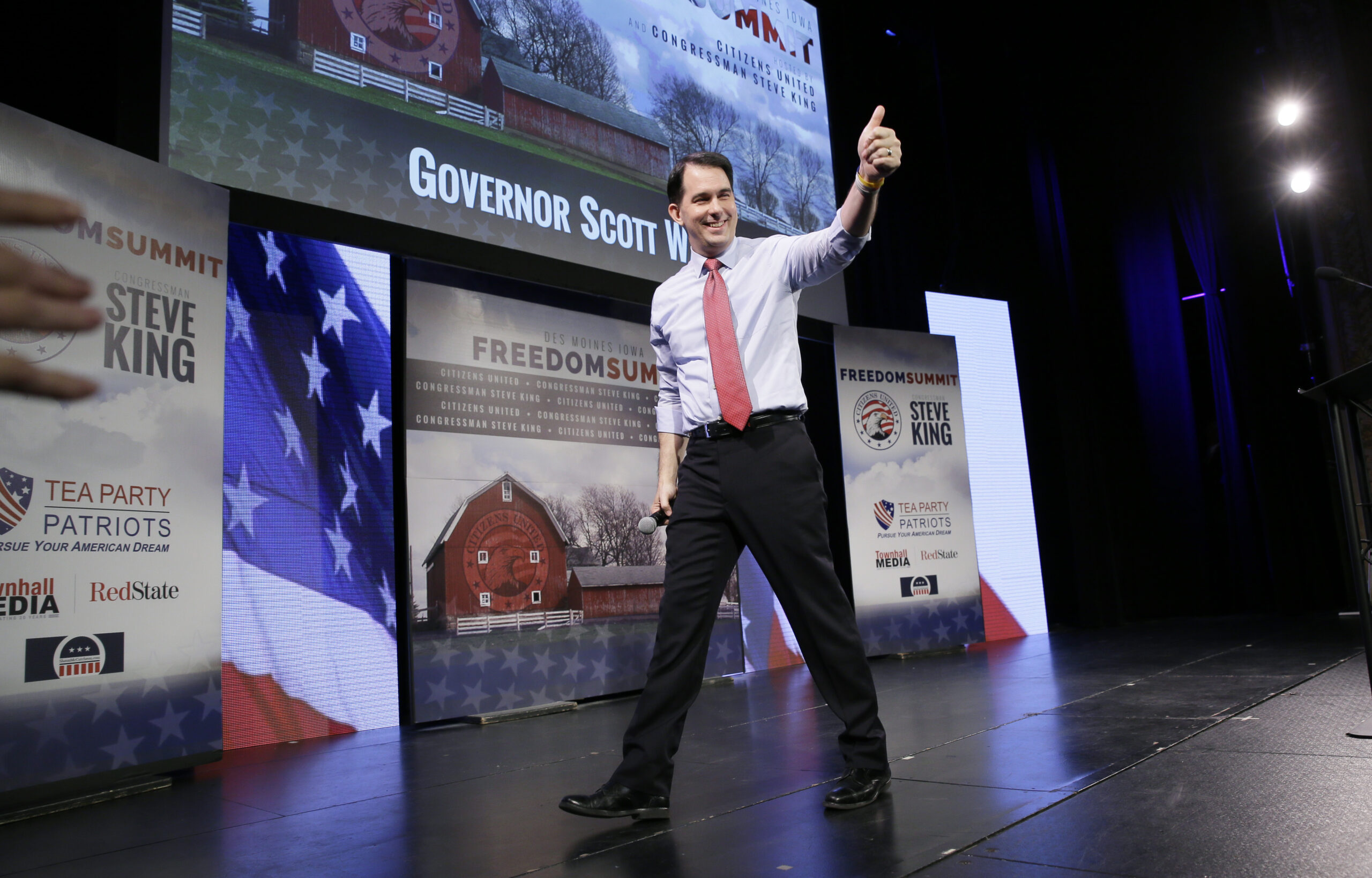 Scott Walker touts his record in Iowa while hinting he’ll run for president