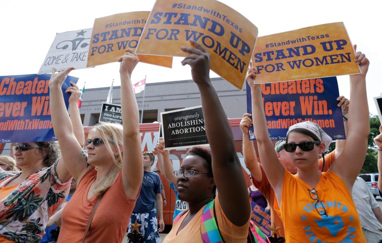 Activists file new lawsuit challenging Texas abortion ban Opponents and supporters of an abortion bill hold signs near a news conference outside the Texas Capitol, in Austin, Texas.