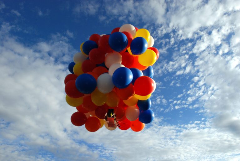   FILE- This July 5, 2008 file photo shows Kent Couch riding a lawn chair rigged with giant party ballons after taking off from his gas tation in Bend, Ore. Couch is planning to fly again July 14, 2012, in a tandem rig with Iraqi adventurer Fareed Lafta on a flight they hope will take them some 400 miles. It is a warm-up for a flight the two men are planning for this fall in Iraq. (AP Photo/Jeff Barnard, File)  