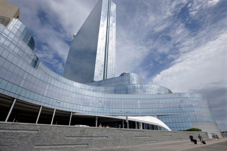 FILE - In this Sept. 1, 2014, file photo, Randy Chapman, left, of California, and John Krisel, of New York, walk on The Boardwalk of the closing Revel Casino Hotel in Atlantic City, N.J. On Oct. 1, 2014, Revel's management chose Brookfield Asset Management as the winner in a bankruptcy court auction for Atlantic City's former Revel Casino Hotel with a $110 million bid. But Florida developer Glenn Straub says the auction was rife with improprieties, and will challenge the result at a hearing Tuesday, Oct. 7, 2014, in Camden, N.J. (AP Photo/Mel Evans, File)