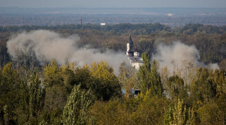 Smoke rises over the Svyato-Iversky Women's Monastery during artillery battle near to the airport in the town of Donetsk, eastern Ukraine Tuesday, Oct. 7, 2014.  Despite a cease-fire declared a month ago between the Ukrainian forces and pro-Russian rebels, the biggest city in eastern Ukraine remains embroiled in fighting .  (AP Photo/Dmitry Lovetsky)