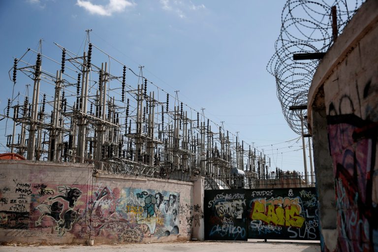 Graffiti is painted on walls and the entrance of an electric station of Public Power Corporation (PPC) in Athens, on Wednesday, July 2, 2014. PPC workers are threatening with rolling strikes to protest government plans to sell a stake in the company to private investors. The conservative-led government is warning that a protracted strike could lead to blackouts at the height of Greece's key tourist season, and has said it could try to force PPC workers back to work through a mobilization order. (AP Photo/Petros Giannakouris)